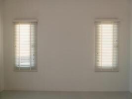 Illuminated minimalist space white walls and blinds create a bright environment photo