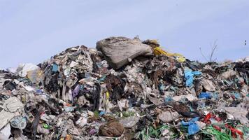 A significant accumulation of garbage, including plastic and other materials, is visible at this landfill site where pollution is a major concern video