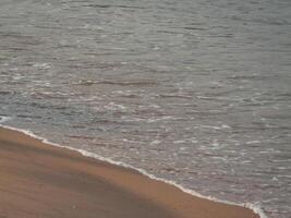 Serene coastal scene waves crashing sandy beach tranquil nature setting photo