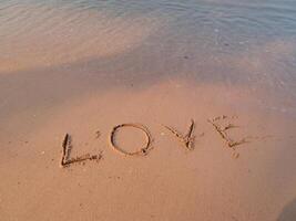 Beach love message coastal shore sand art romantic setting close-up heartfelt expression photo