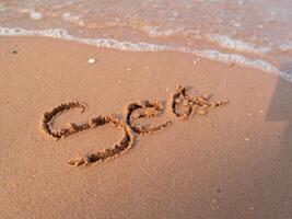 Writing the sand a personal message the beach coastal environment close-up view photo