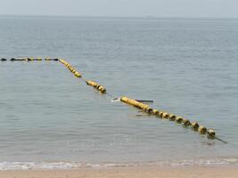 Floating barrier at shoreline coastal area nature calm waters close-up environmental protection photo