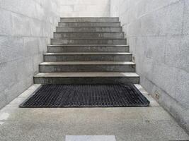 Staircase entrance with mat modern architecture indoor space neutral palette ground level view photo