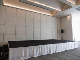 Event stage setup for corporate presentation modern venue professional atmosphere wide angle view photo