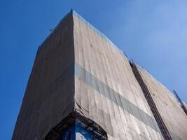 Construction progress update urban site clear sky low angle building development photo