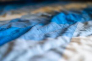 Dynamic blue wave patterns abstract art textiles indoor close-up visual serenity photo