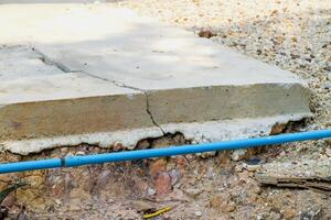 Structural integrity in urban construction cracked concrete slab and exposed pipe details photo