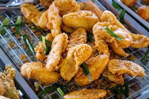 Crispy fried chicken bites local market food vibrant setting close-up culinary delight photo