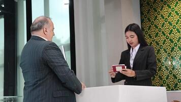 Check In. Business or traveler people checking in at an airport counter. Friendly staff review passports and documents. Scene of airline service and airport check in airport service and travel comfort video