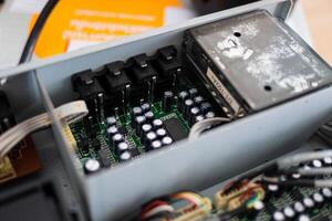 Examining circuit board components in a technology workshop close-up view industrial environment photo