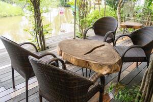 Tranquil outdoor seating area by a serene lake a nature retreat with inviting atmosphere photo
