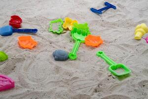 Children's beach playtime action sandy shore toy shapes seaside close-up fun creativity photo