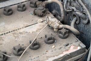Inspecting a dusty vehicle battery garage workshop industrial setting close-up maintenance insight photo