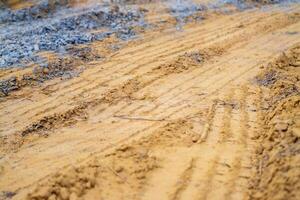 Tractor treads freshly plowed soil farm field close-up view agricultural concept photo