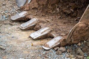 Excavation machinery in action construction site close-up earthy environment ground level view photo