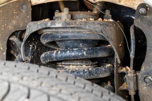 Vehicle suspension system close-up automotive workshop technical indoor detailed view photo