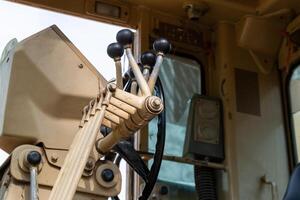 Construction equipment operators control heavy machinery at job site industrial environment close-up view photo