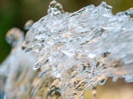 Flowing water action shot nature park macro tranquil environment close-up view water movement concept photo