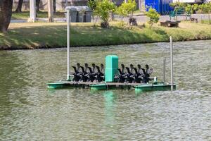 Urban park floating platform aerial view of water-powered paddle boat recreation photo
