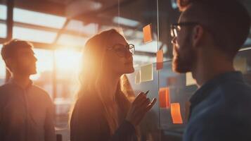 Creative teamwork and brainstorming session in a bright office environment during sunset photo