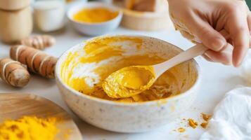 Creating a vibrant turmeric mixture in a cozy kitchen setting while preparing ingredients for a culinary project photo