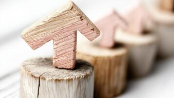 Wooden arrows pointing upward arranged on rustic wooden bases symbolize growth and progress in personal development photo