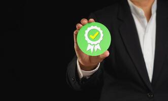 The best quality symbol assurance for a service, and ISO certification on a hand businessman. Space for text. photo