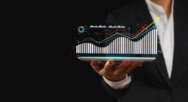 The growth of a business is displayed as a virtual graph on a tablet screen photo