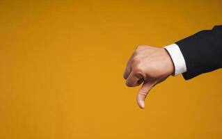 Negative concept. Close-up of hand showing a thumbs down for dislike service photo