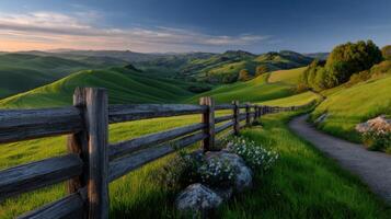 Rolling green hills and wooden fence create a peaceful and scenic rural landscape at sunset perfect for nature lovers photo