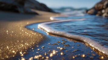 Golden sunlight dances on gentle waves lapping the sandy shore creating a tranquil beach scene photo