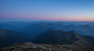 Scenic alpine mountain landscape with beautiful sunset colors over the majestic peaks in the Alps Europe photo