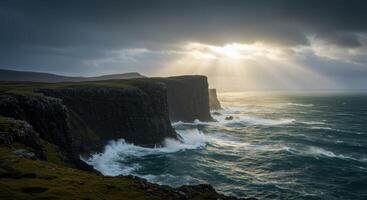 Dramatic Scottish Highlands coastline landscape with sun rays breaking through storm clouds over rocky cliffs and crashing waves photo