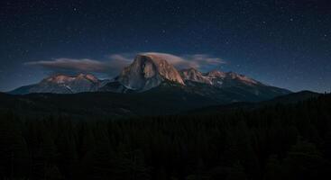 Dramatic mountain range under a starlit night sky displaying a beautiful majestic natural scenery photo