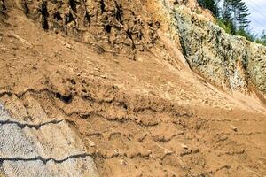 Rugged sediment layers cascade like ancient historys tapestry, revealing geologists dreams and Earth Days quiet meditative gaze photo