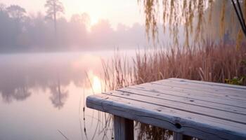 Sunrise over misty lake with wooden table photo