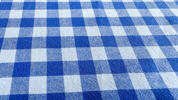 Blue gingham tablecloth celebrating Picnic Day evokes rustic charm, perfect for Bastille Day feasts or family reunions photo