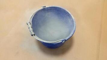 A mystical blue bucket echoes chalky memories, encapsulating the essence of Holi festivities and quirky DIY adventures photo