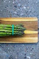 Vibrant asparagus clustered on a rustic board, celebrating quirky National Asparagus Day, evoking earthy spring equinox rituals photo
