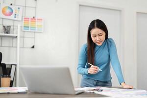 Design Workspace and Creative Planning. A designer focuses on color palette selection while analyzing digital resources. photo