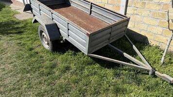 Rustic trailer basks in sunshine, whispering tales of harvest festivals and countryside escapades, embodying rural nostalgia and simplicity photo