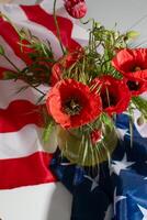 Vibrant poppies cascade over draped American flag, symbolizing Memorial Day reverence and Independence Days spirited unity and remembrance photo