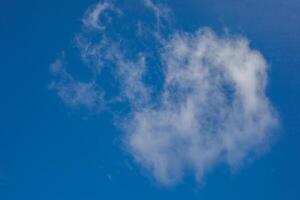 Fluffy cloud whispering cryptic tales in cobalt sky, reminiscent of Dream Day contemplation and World Cloud Appreciation photo