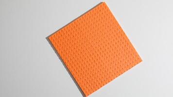 An orange textured square napkin evokes retro mod aesthetics, quirky decor vibes, and Tangerine Day festivities photo