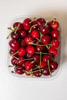 Luscious cherries nestle in a glistening plastic cradle, evoking Hanami picnics and quirky Flaugnarde feasts, juicy temptations await photo