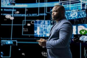 Portrait of a black professional engaged in coding and analytics, surrounded by AI neural networks and data visualization systems. Future of tech innovation with artificial intelligence. photo