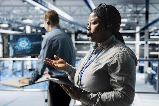 Team of data center experts delivering comprehensive user support and issue resolution using AI. Server farm colleagues diagnosing customers issues through support tools and headset mic photo