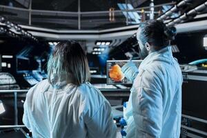 Team of astronauts doing brainstorming before landing spaceship on Mars. Teamworking orbit station colleagues doing mission on red planet surface to test human survival in deep space photo