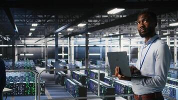 Engineers in data center using laptop to monitor neural network LLM visualization. Coworkers on server hub industrial platform overseeing server clusters powering machine learning processes, photo