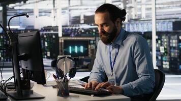 Angry data center engineer banging fist on desk after seeing system failure. Server farm IT expert reacting furiously to unstable infrastructure performance, leaving office, camera A photo